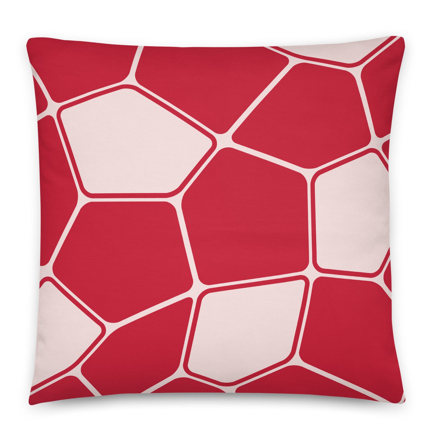 A square throw pillow featuring a modern geometric pattern of red and pale pink irregular polygon shapes outlined in white.