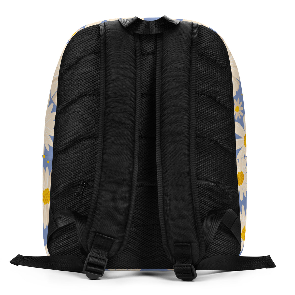 The back view of a backpack featuring a black mesh back panel with padded shoulder straps, set against a light beige side panel decorated with a blue and yellow daisy floral pattern.