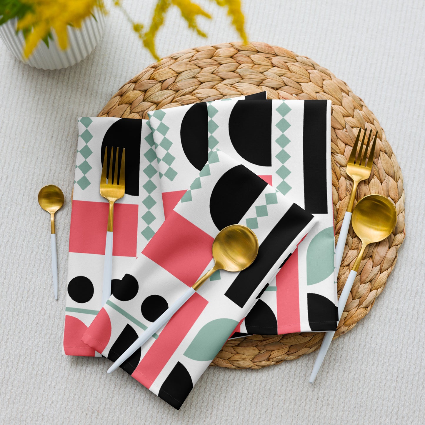 cloth napkins white, black, coral pink, and mint green shapes.