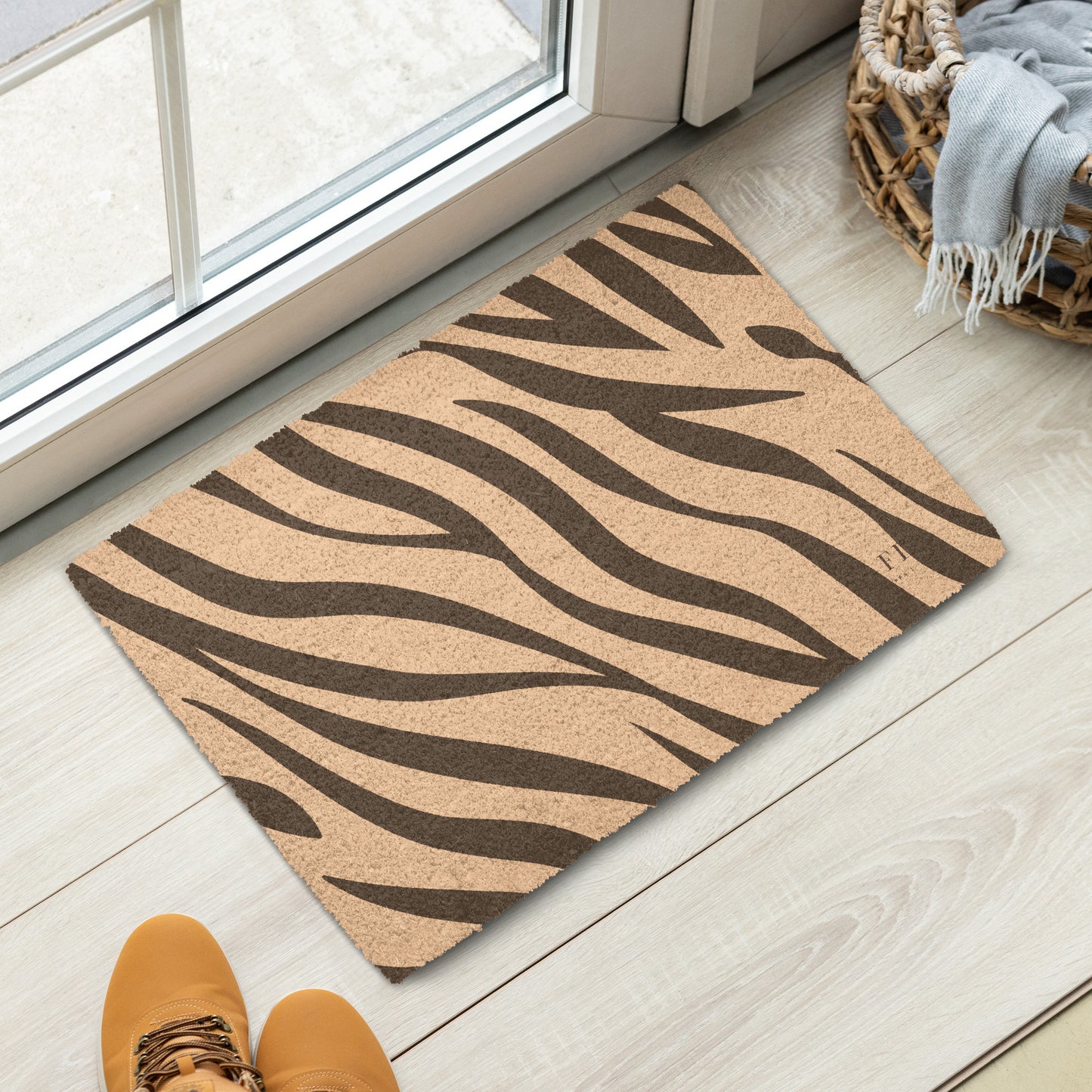 A rectangular coir doormat with a brown zebra stripe pattern.