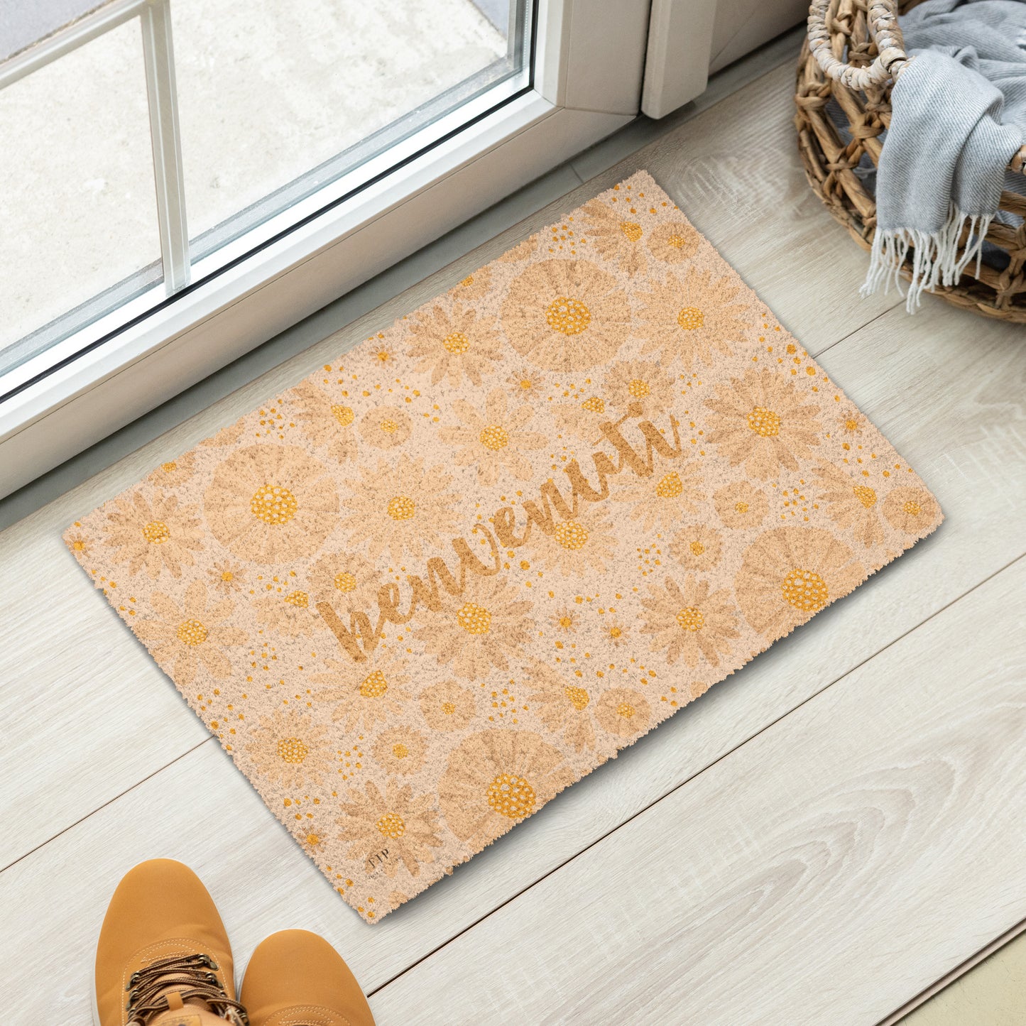 A rectangular doormat with a warm beige and yellow floral pattern and the word 'bienvenuti' in script