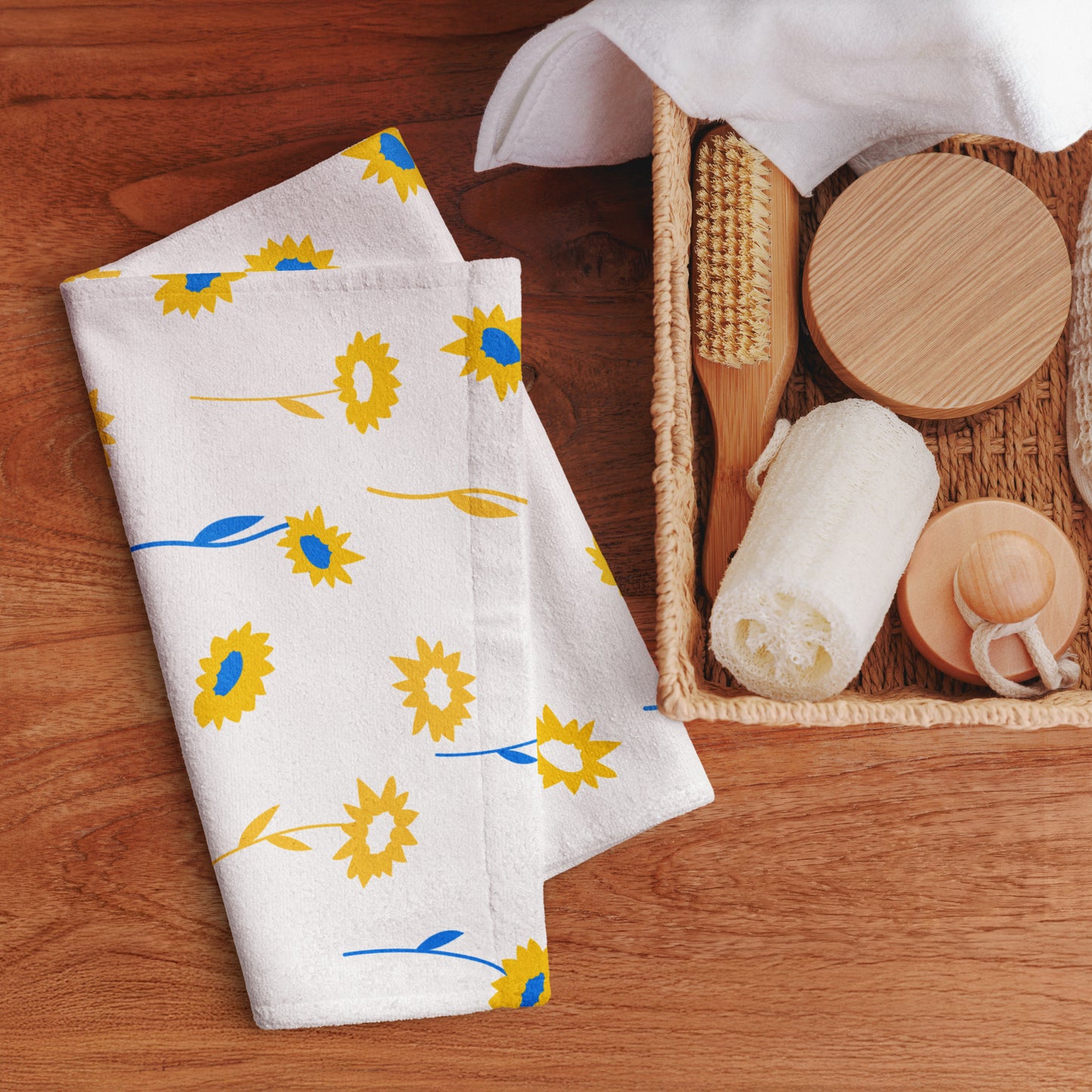 White cotton towel with a yellow sunflower and blue leaf pattern.