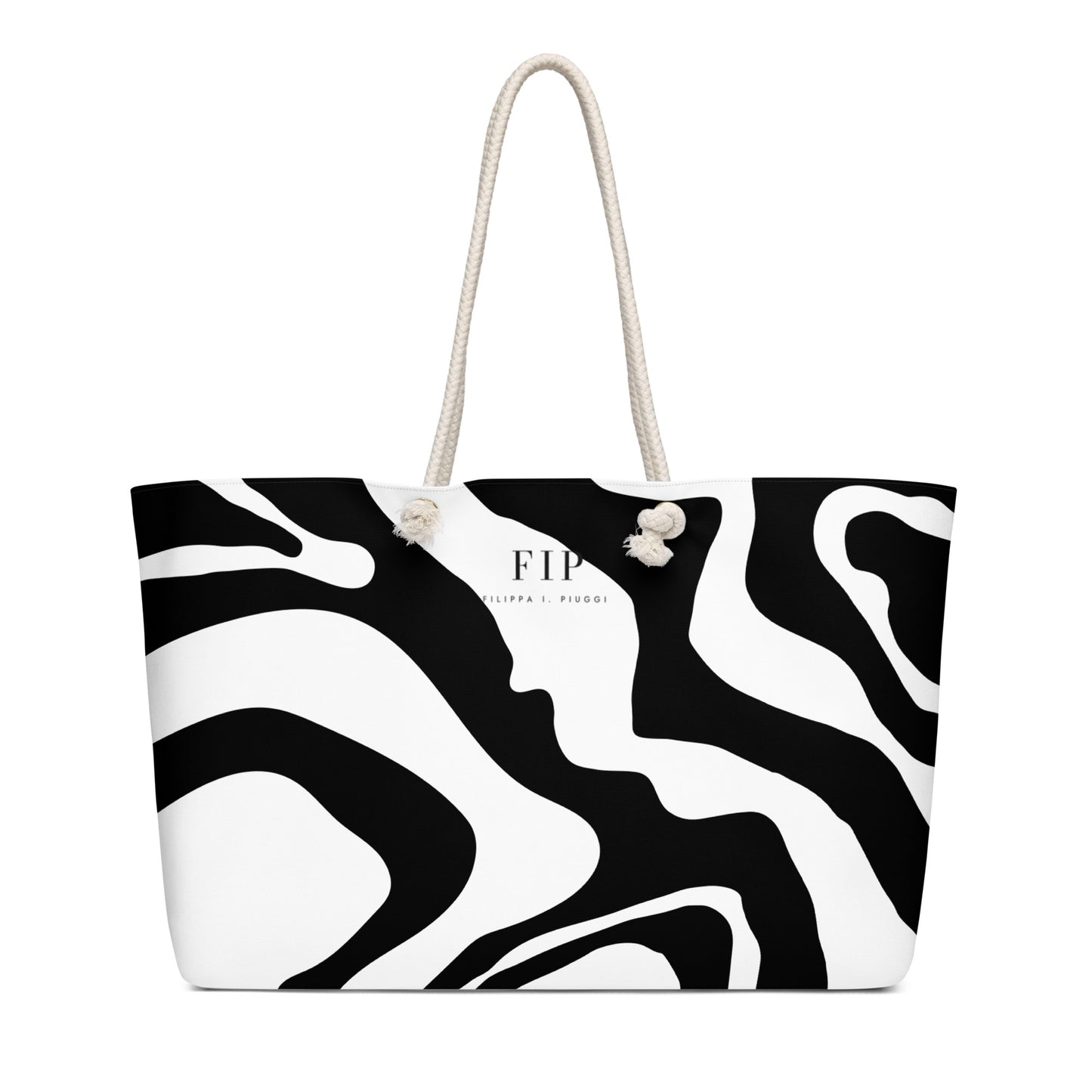 A black and white abstract patterned tote bag with cream-colored rope handles.