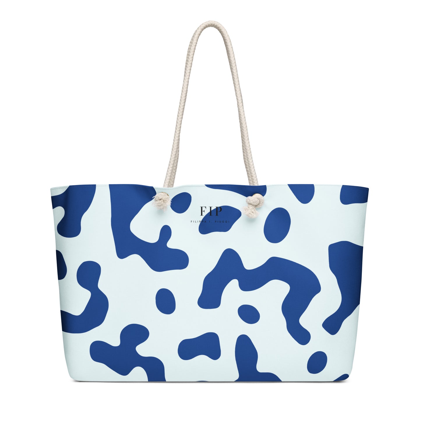 A tote bag with an abstract blue and white pattern, featuring two thick cream-colored rope handles.