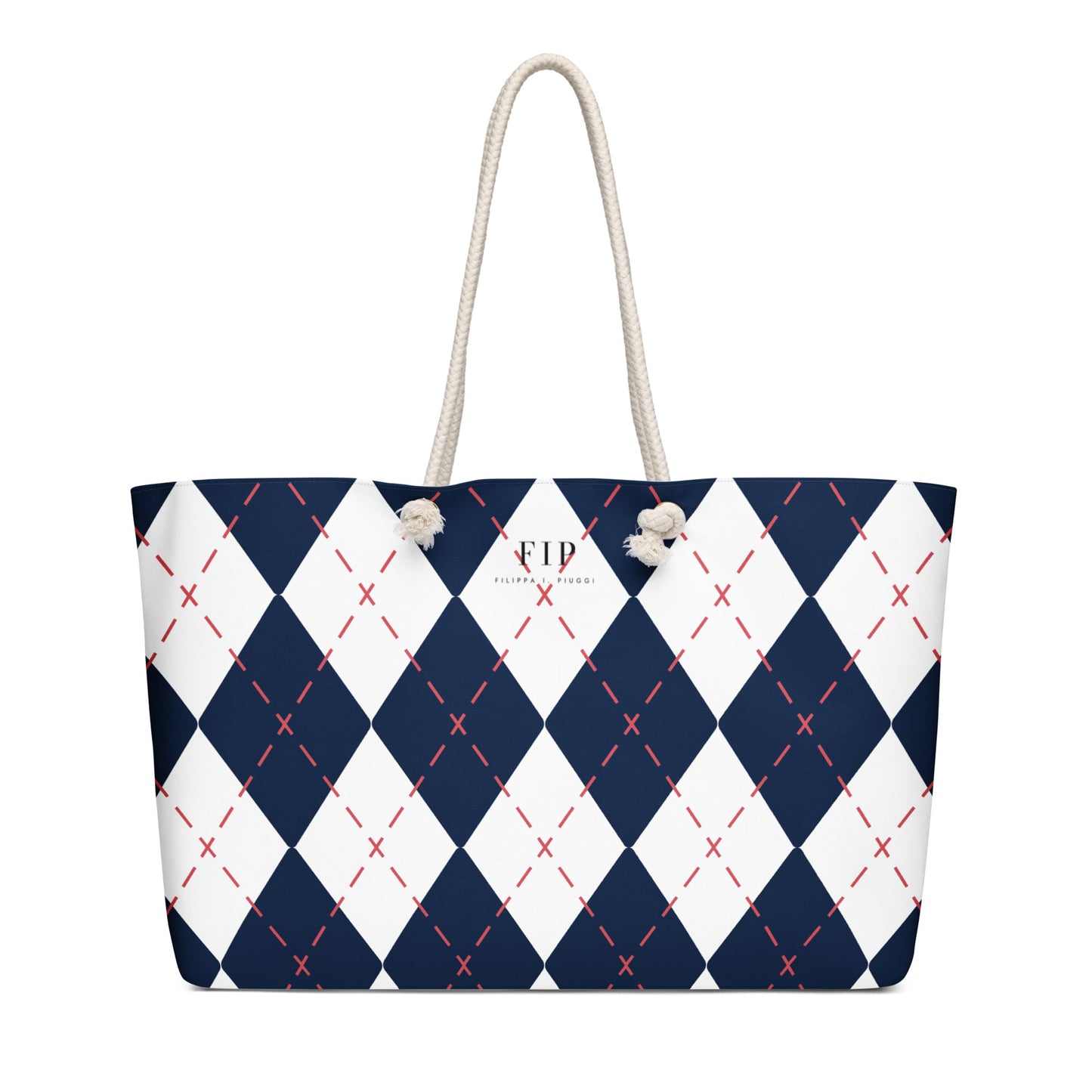 A tote bag with a navy blue and white argyle pattern, accented with thin red dashed lines and featuring off-white rope handles.