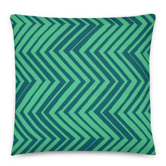 A square throw pillow featuring a bold chevron pattern in shades of green and dark teal. 