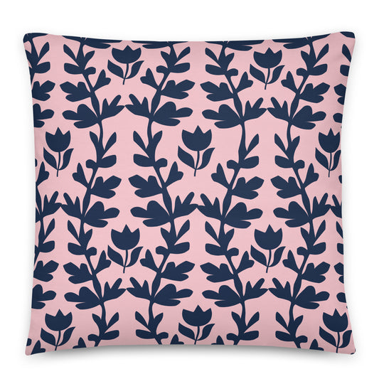 A square throw pillow featuring a repeating navy blue botanical vine pattern on a soft pink background.