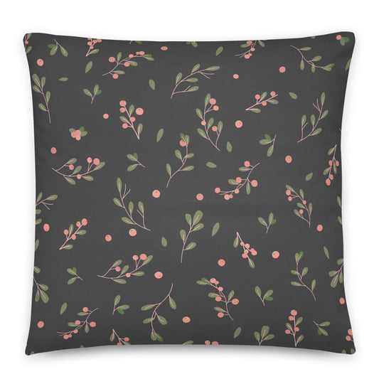 A square throw pillow featuring a dark charcoal gray background with a repeating pattern of delicate pink berries, green leaves, and thin pink stems. 