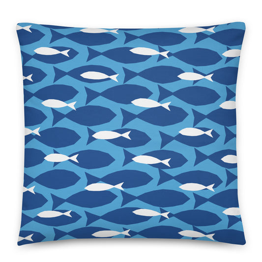A square throw pillow featuring a repeating pattern of stylized fish in shades of blue and white. 