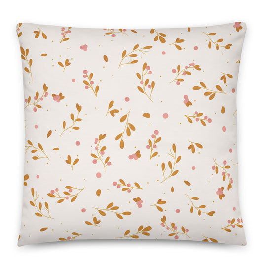 A square throw pillow featuring a delicate botanical pattern of gold-brown leaves, pink berries, and small gold dots on a warm off-white background.