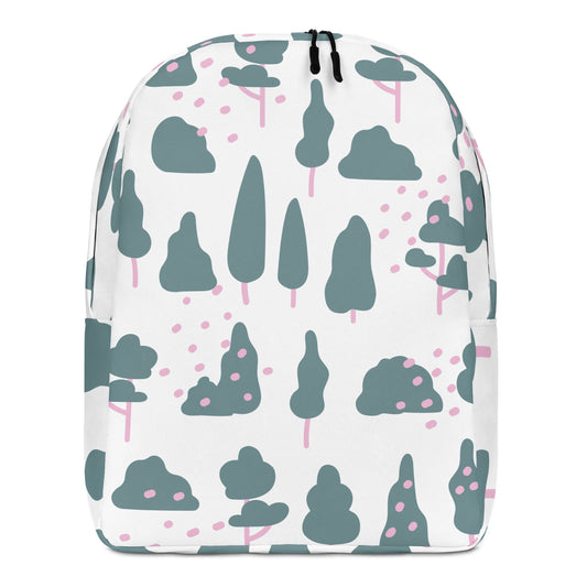 A white backpack featuring a playful pattern of stylized trees and bushes in muted teal and pink, with black zipper pulls at the top.