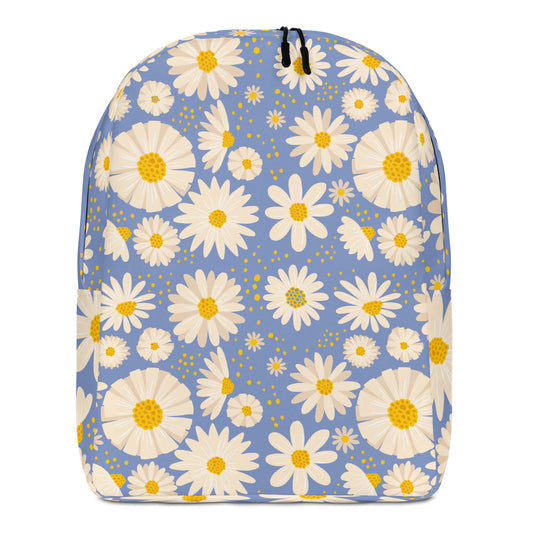 A backpack with a light blue background covered in a white and yellow daisy floral pattern, featuring black zipper pulls at the top