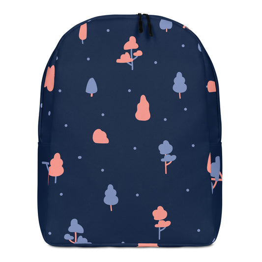 A navy blue backpack featuring a whimsical pattern of stylized trees in coral pink and light blue, accented with small white dots