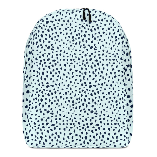 A backpack with a light blue and navy blue dalmatian spot pattern, featuring a black zipper at the top