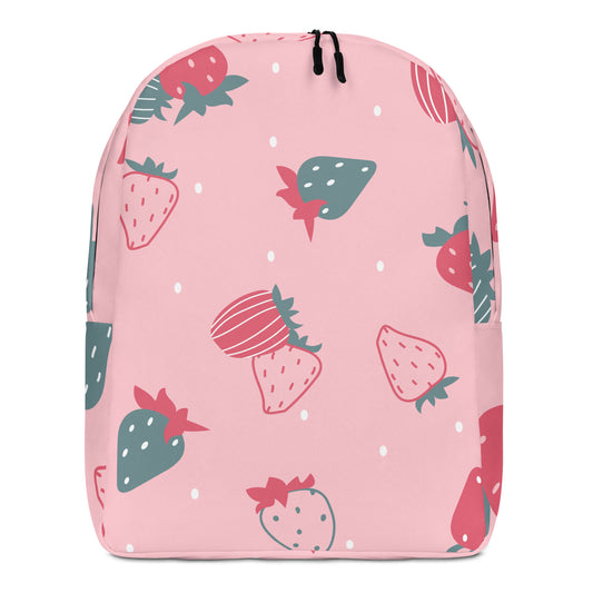 A pink backpack featuring a strawberry pattern in red and green, with small white dots