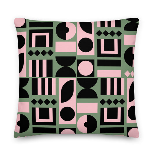A square throw pillow featuring a bold geometric pattern of pink, black, and sage green shapes 