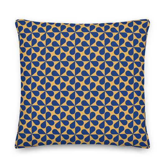 A square throw pillow featuring a repeating geometric pattern of blue teardrop shapes on a mustard yellow background