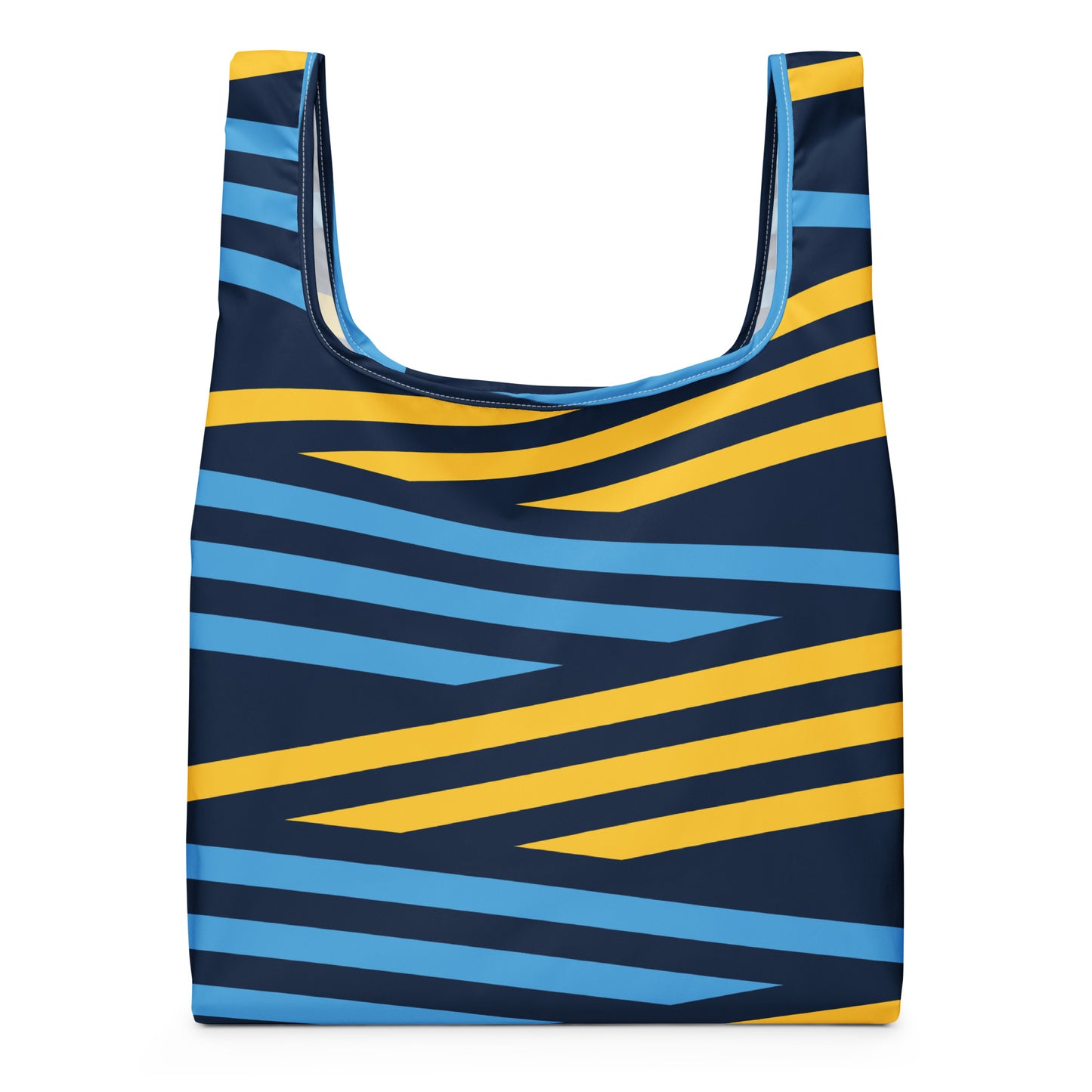A reusable tote bag with a bold geometric pattern of diagonal stripes in yellow and light blue on a dark navy background. 