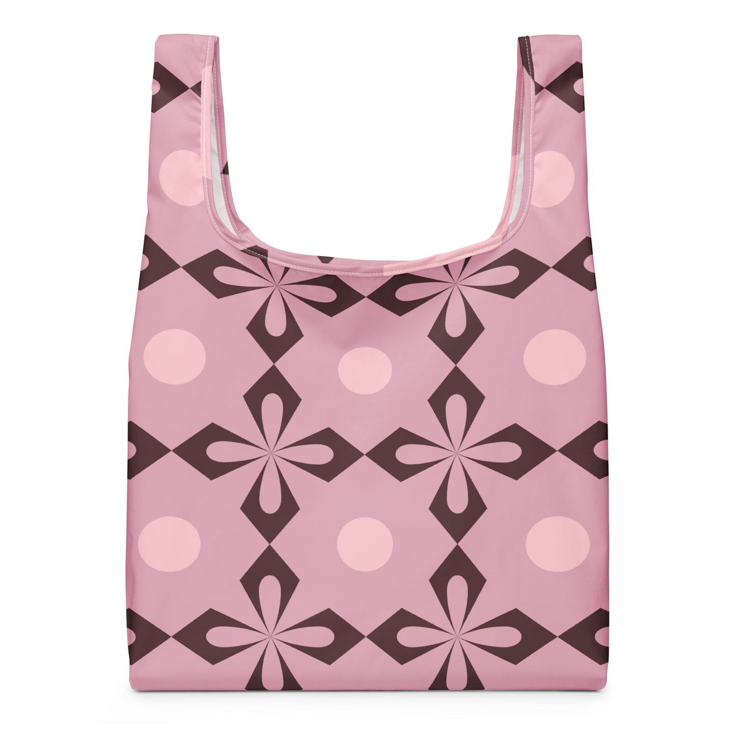 A reusable shopping bag with a retro geometric pattern in pink, light pink, and dark brown.