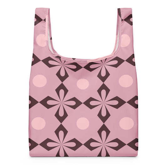 A reusable shopping bag with a retro geometric pattern in pink, light pink, and dark brown.