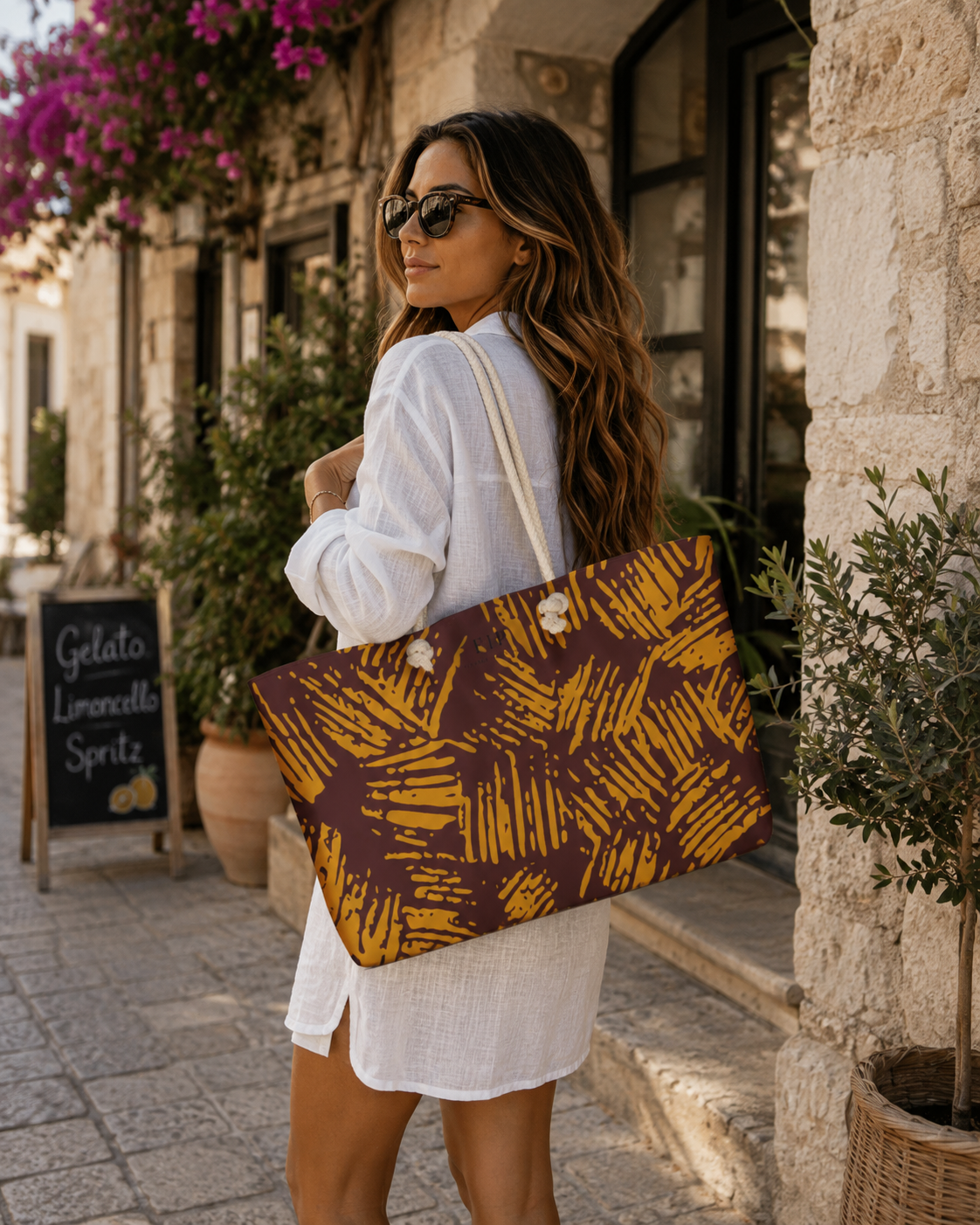 a large tote bag with a mustard yellow and dark brown abstract brushstroke pattern 