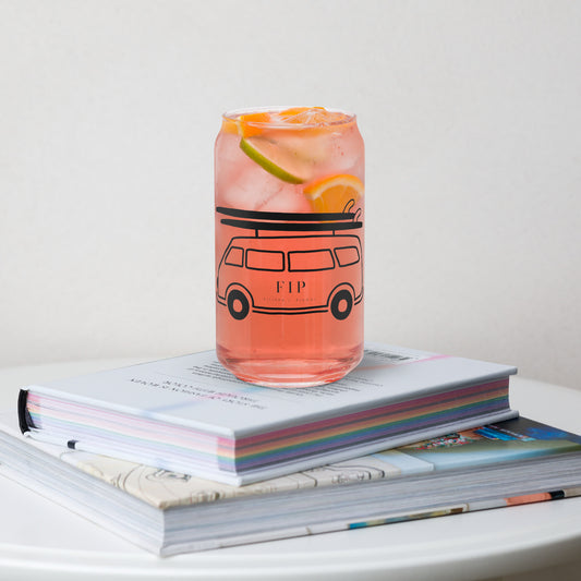 A clear glass can-shaped tumbler with a bus. 