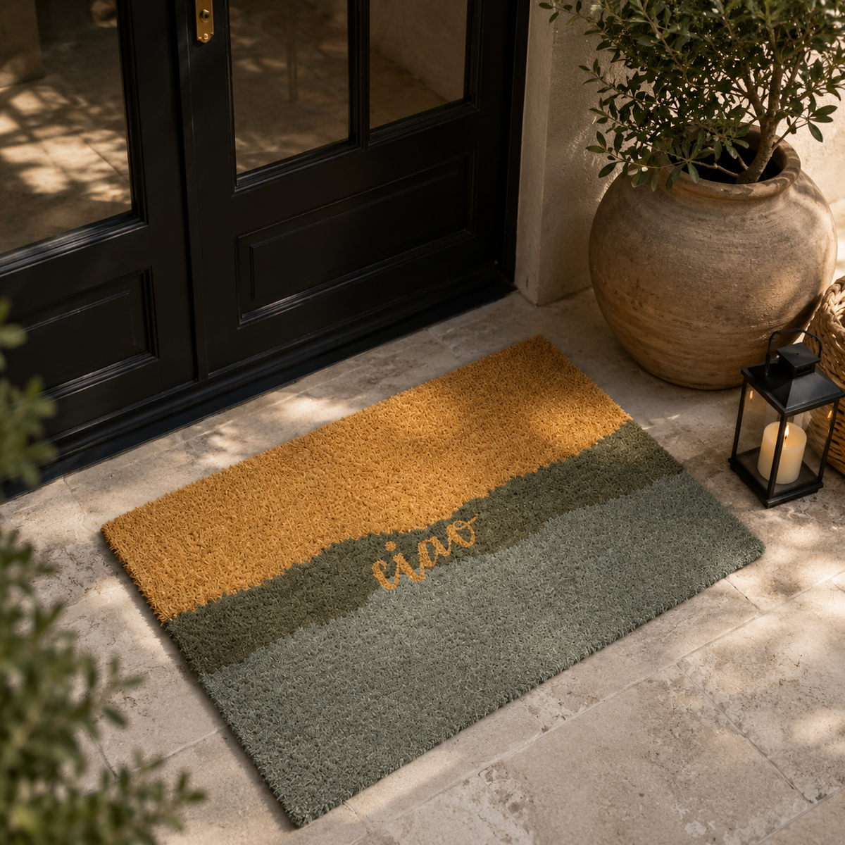A rectangular shag doormat with horizontal color-blocked stripes in mustard yellow, olive green, and sage green, featuring the word 'ciao in yellow script across the center. 