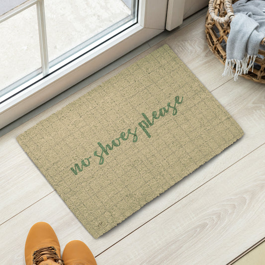 A rectangular natural coir doormat with the phrase 'no shoes please' in green script