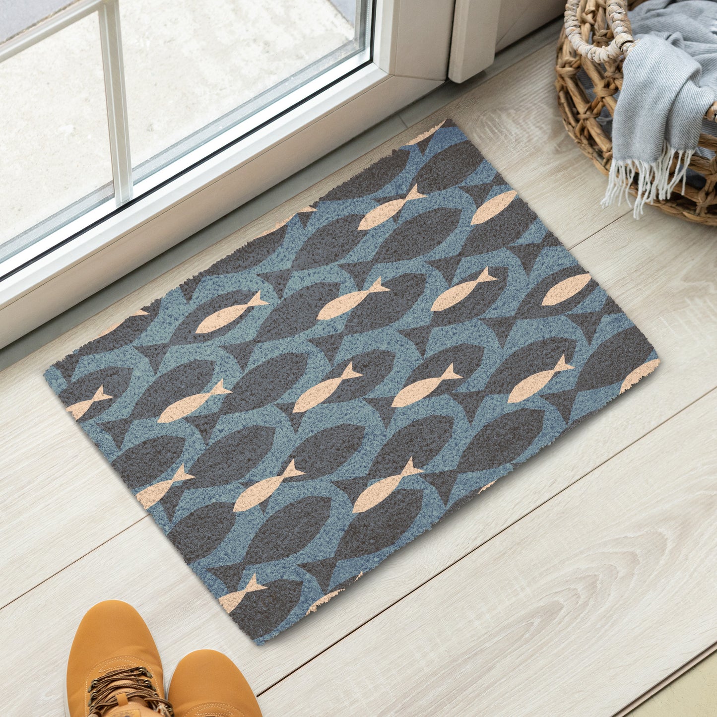 A rectangular doormat with a repeating fish pattern in dark charcoal, slate blue, and beige
