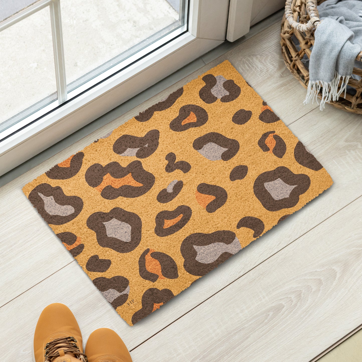 A rectangular coir doormat with a brown, gray, and orange leopard print pattern.