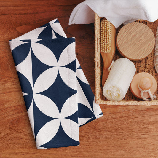Hand towel with a navy blue and white geometric floral pattern. 