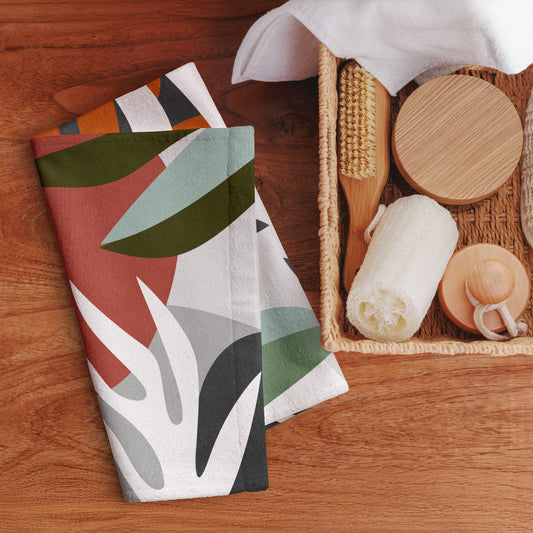 cotton hand towel with abstract leaf-like shapes in terracotta, sage green, light blue, gray, black, and white. 