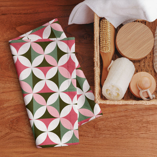 hand  towel with a geometric floral design in pink, green, and white