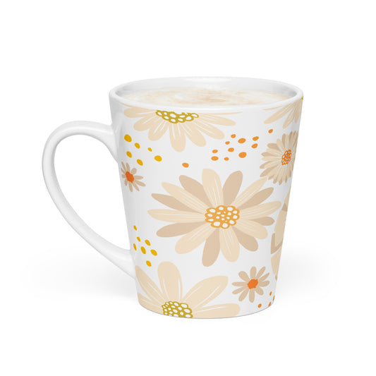 A white ceramic latte mug with a handle, decorated with a pattern of beige and peach daisies with yellow and orange centers