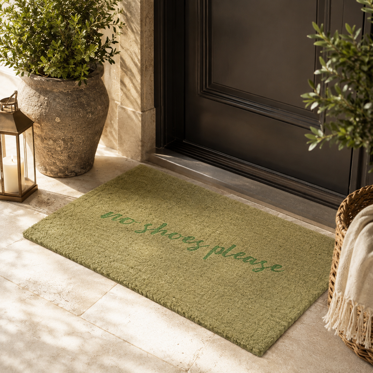 An olive green coir doormat with the text 'No shoes please' in green script,