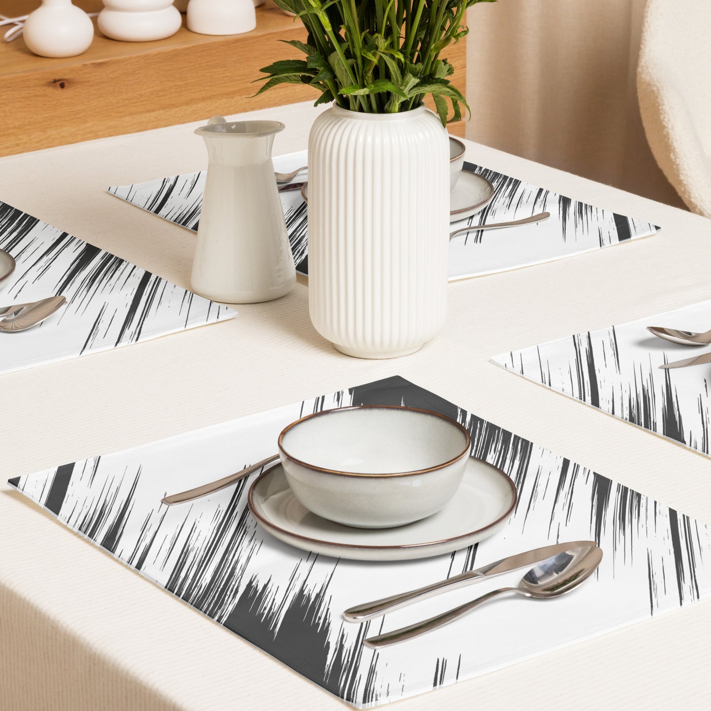 rectangular placemats with a black and white brushstroke pattern