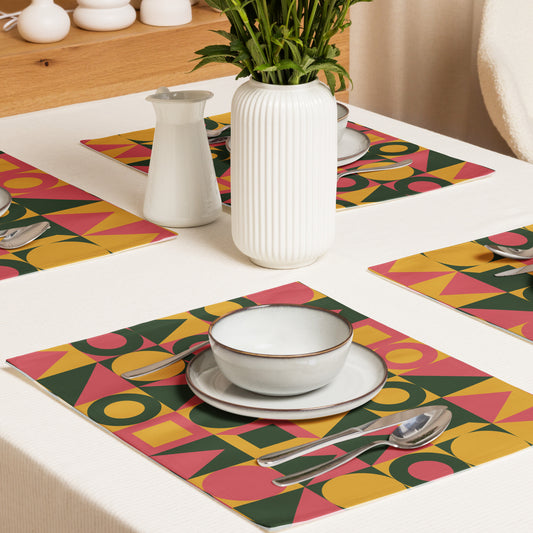 colorful geometric placemats with pink, yellow, and green shapes.