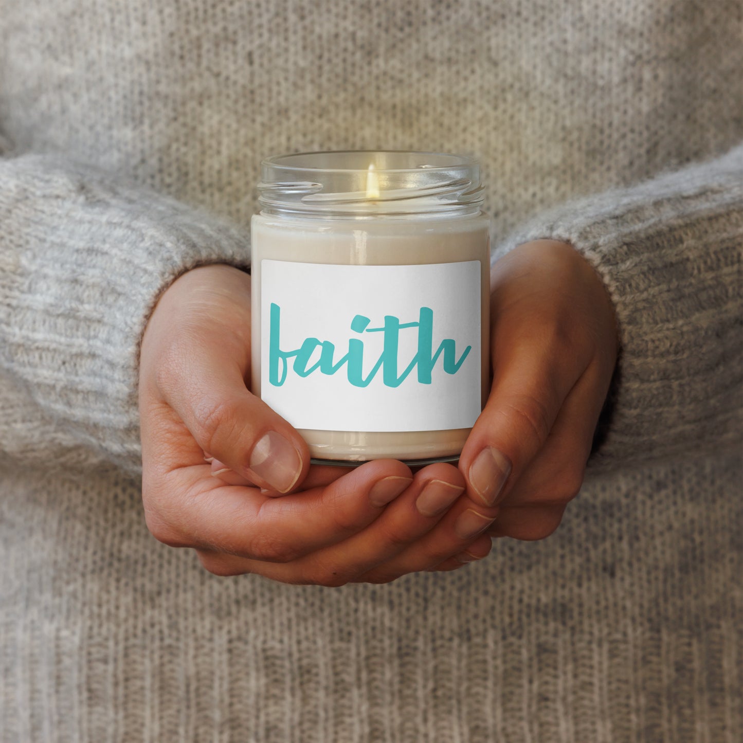 glass jar candle soy scented with a white label that reads 'faith' in teal script.