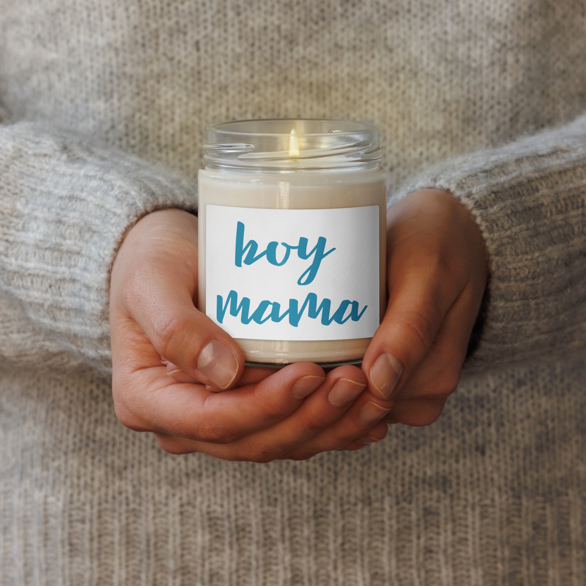 The candle label reads 'boy mama' in blue script. soy scented 