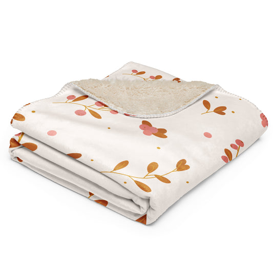  Blanket with a cream-colored base, decorated with a pattern of orange-brown leaves, pink flowers, and small pink dots, featuring a soft beige sherpa lining on the reverse side.