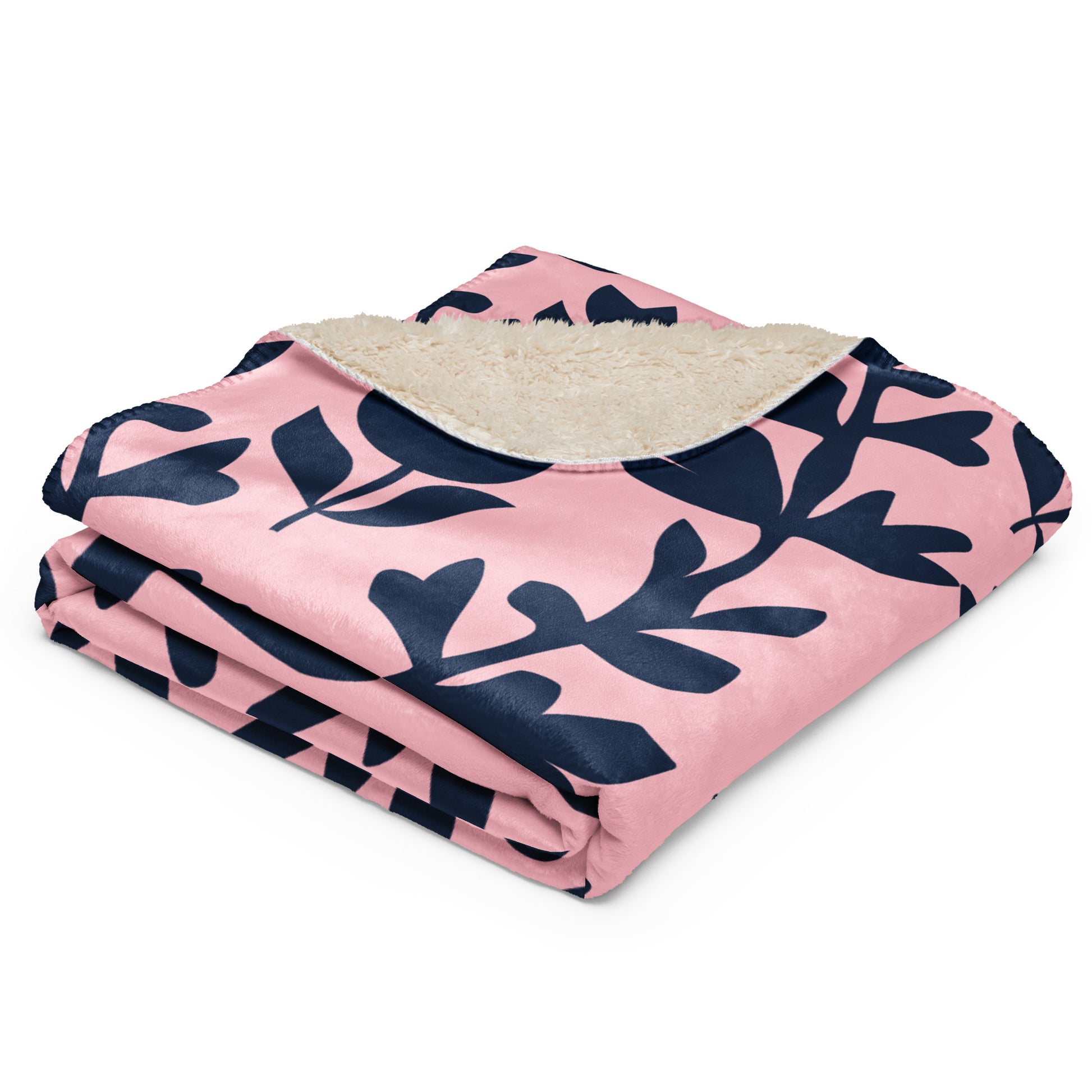 pink sherpa blanket with navy blue leaf pattern.