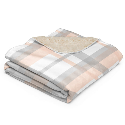 plaid blanket with a soft fleece sherpa lining, featuring a checkered pattern in dusty pink, gray, and white.