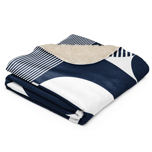 a navy blue and white geometric pattern, a navy and white striped section, and a beige sherpa lining