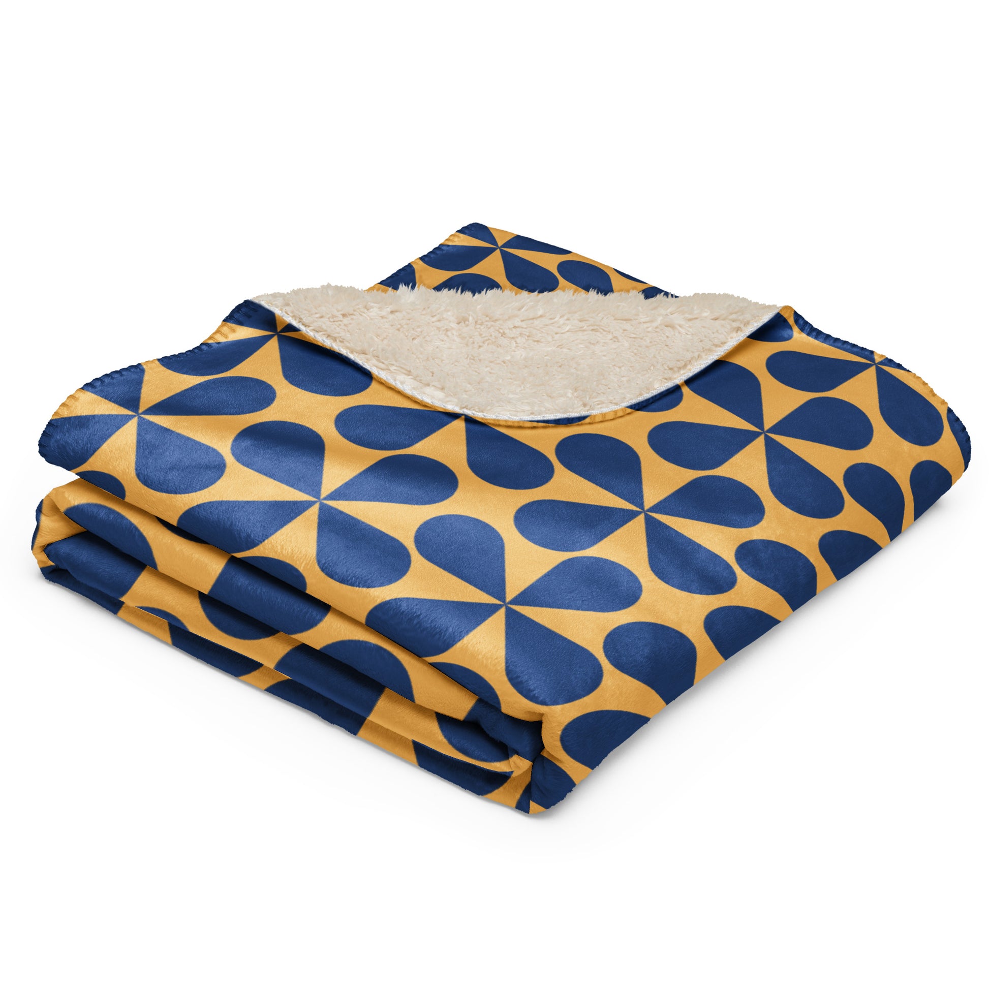 blanket featuring a navy blue and mustard yellow geometric pattern, with a soft beige sherpa lining visible on the underside,