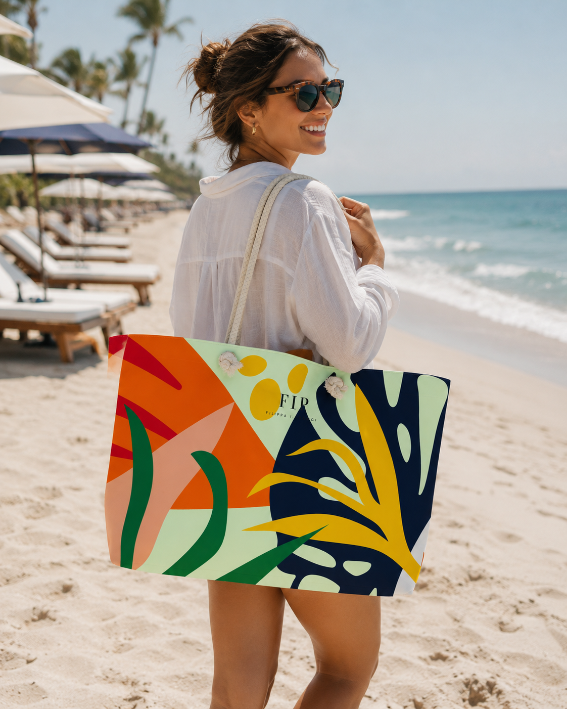 arge tote bag with a colorful abstract tropical leaf pattern in orange, yellow, green, and navy. 