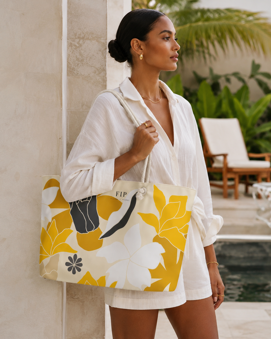 a large tote bag with a bold yellow, white, and dark gray botanical pattern. 