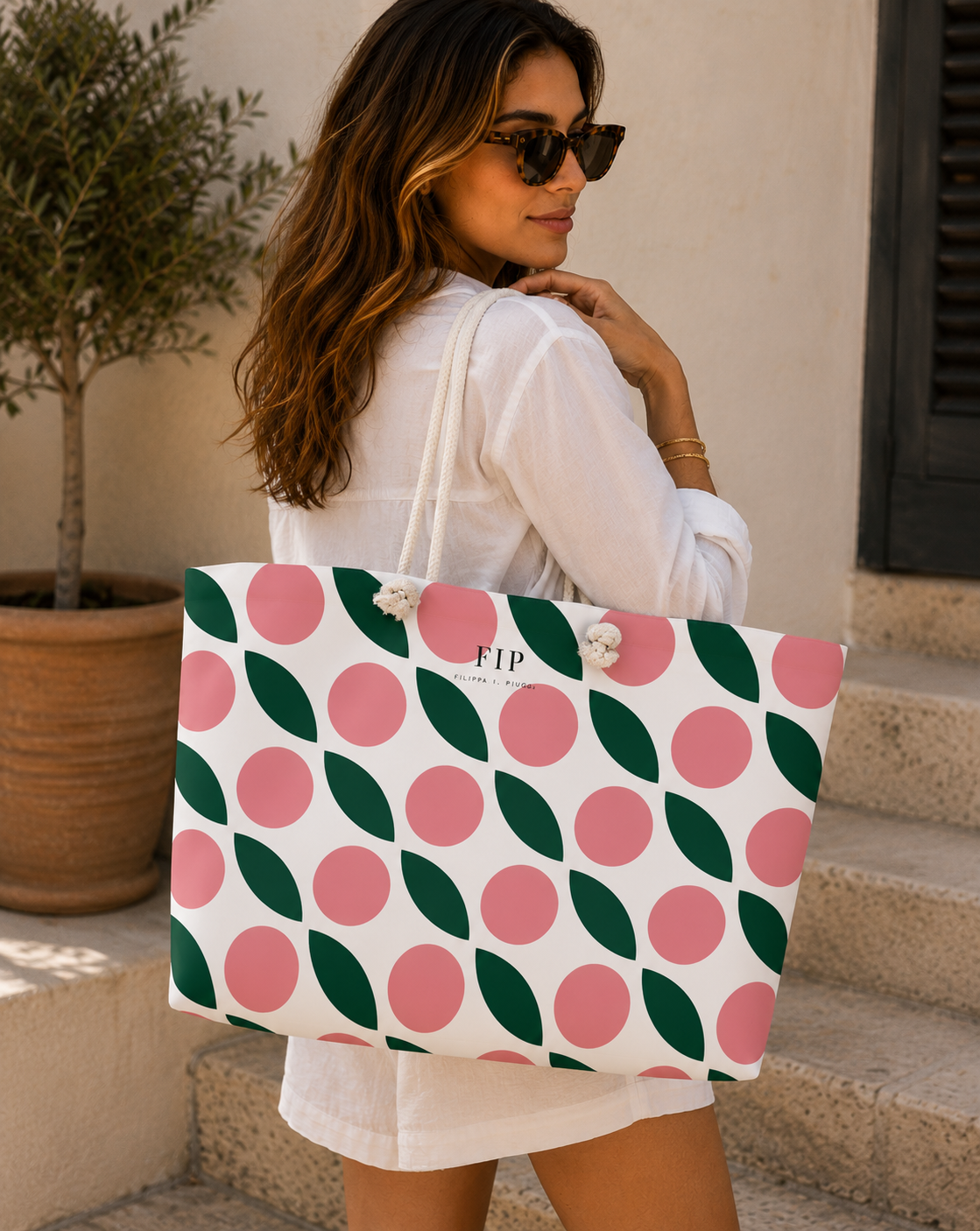 large tote bag with a white background, pink circles, and green leaves. 