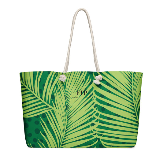 A green and lime tropical palm leaf print tote bag with white rope handles. 
