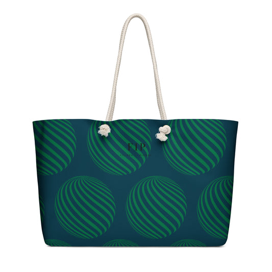 A tote bag with a dark teal and green striped pattern, featuring white rope handles.