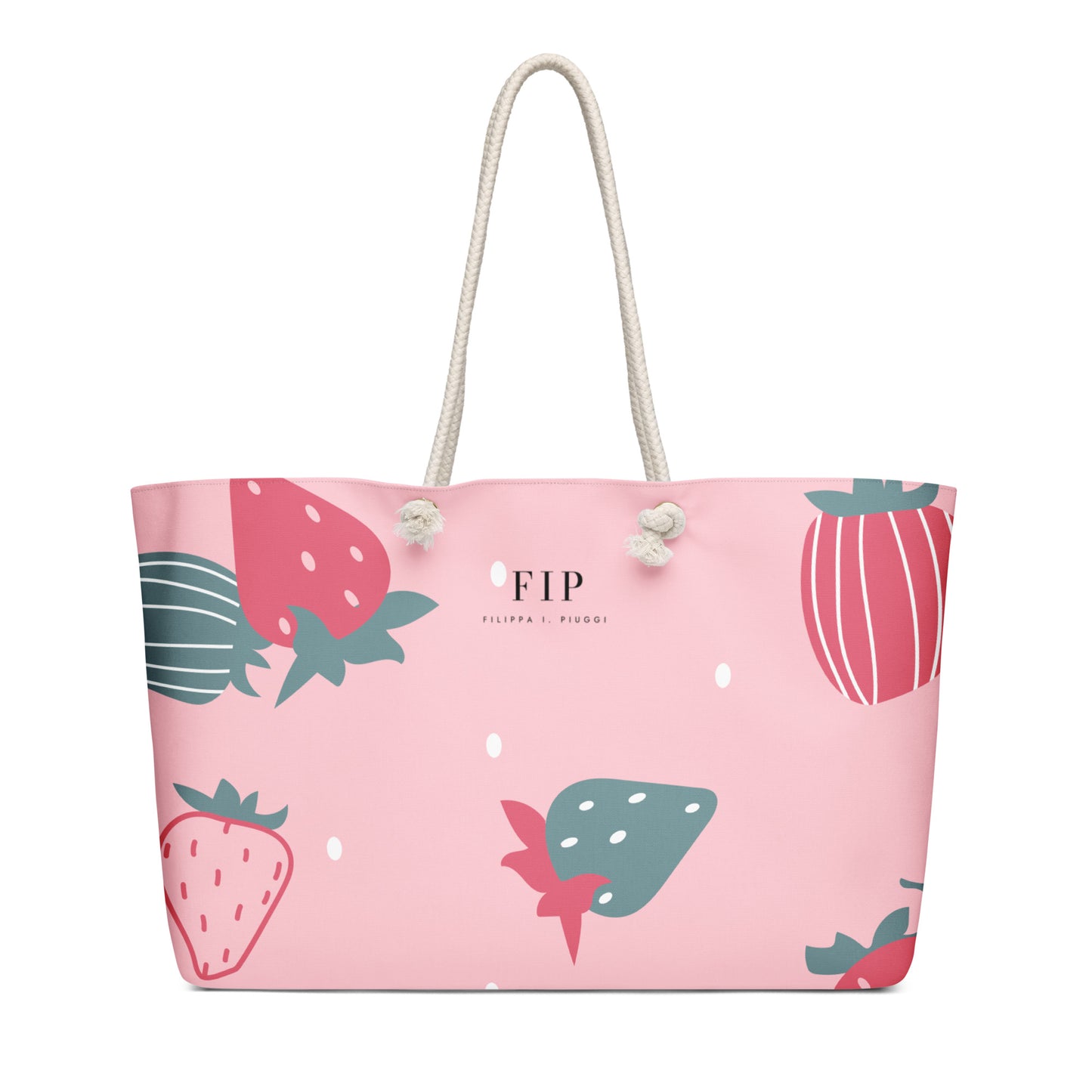 A pink tote bag with a pattern of illustrated strawberries in red and teal, featuring cream rope handles. 